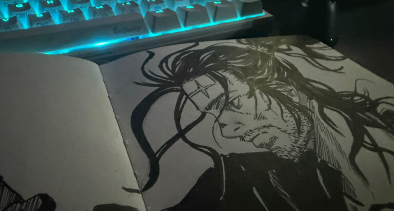 Drawing of miyamoto musashi by allard lavaritte in a sketchbook placed in a computer table